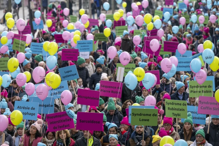 Cortège de la Marche des Maladies Rares : ballons et pancartes aux noms des pathologies